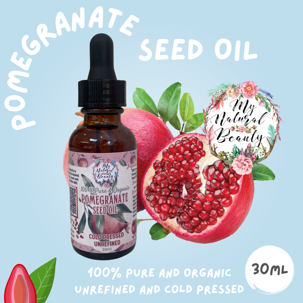 Pomegranate seed oil bottle with pomegranate fruit and leaves on a light blue background