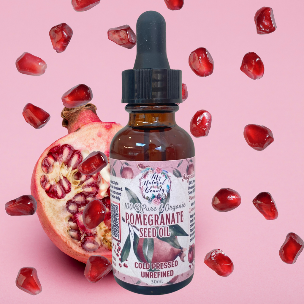 Bottle of pomegranate seed oil with a dropper on a pink background with pomegranate pieces.